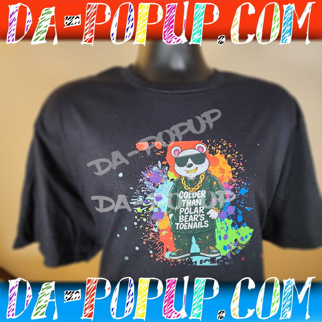 Black t-shirt with a colorful splatter background and a cartoon polar bear wearing sunglasses and chains, with the text Colder Than Polar Bear's Toenails