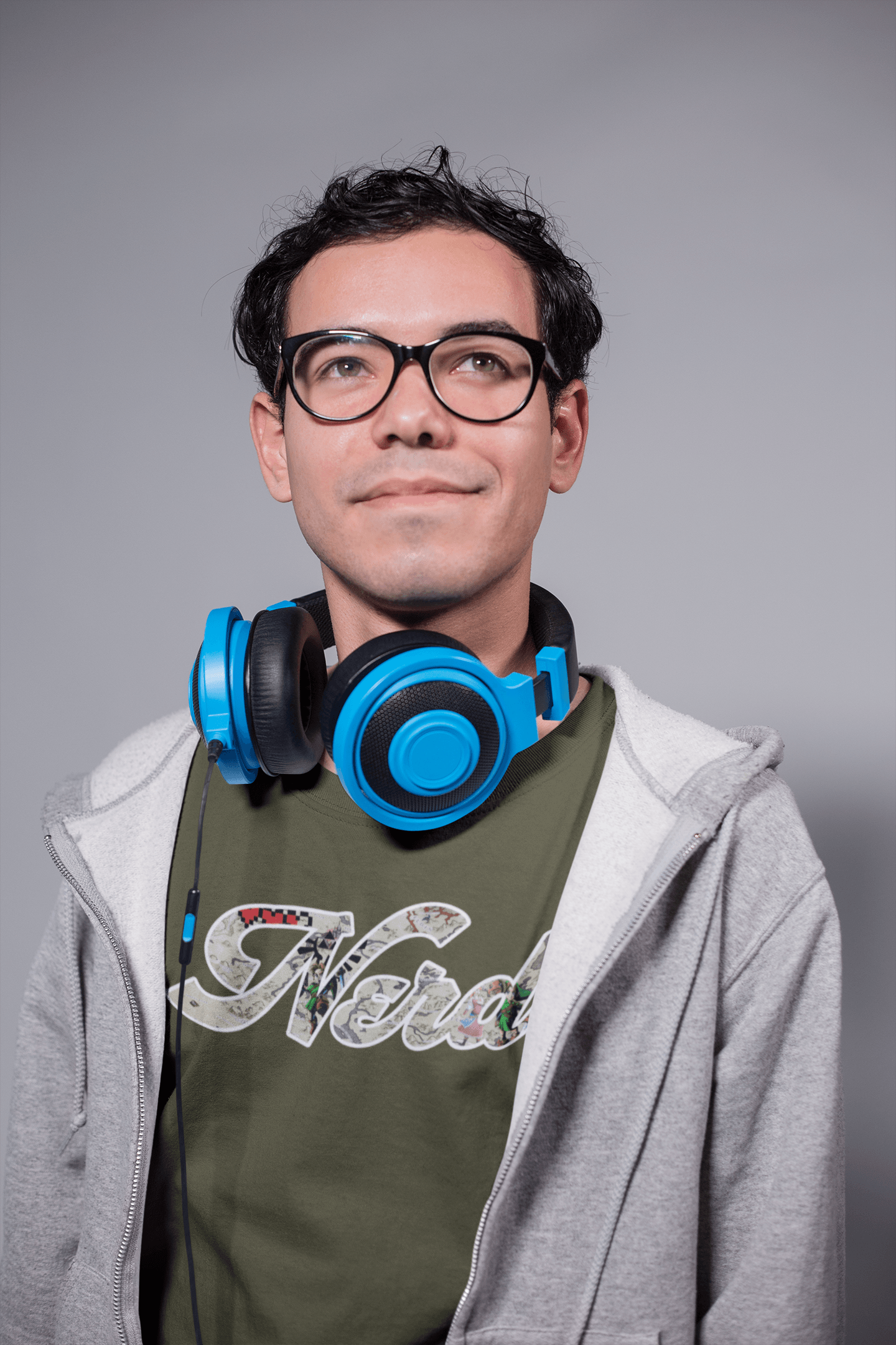 DESIGNER HEADPHONES GREY SWEATER WHITE WALL HANDHELD BLACK GLASSES SMILE